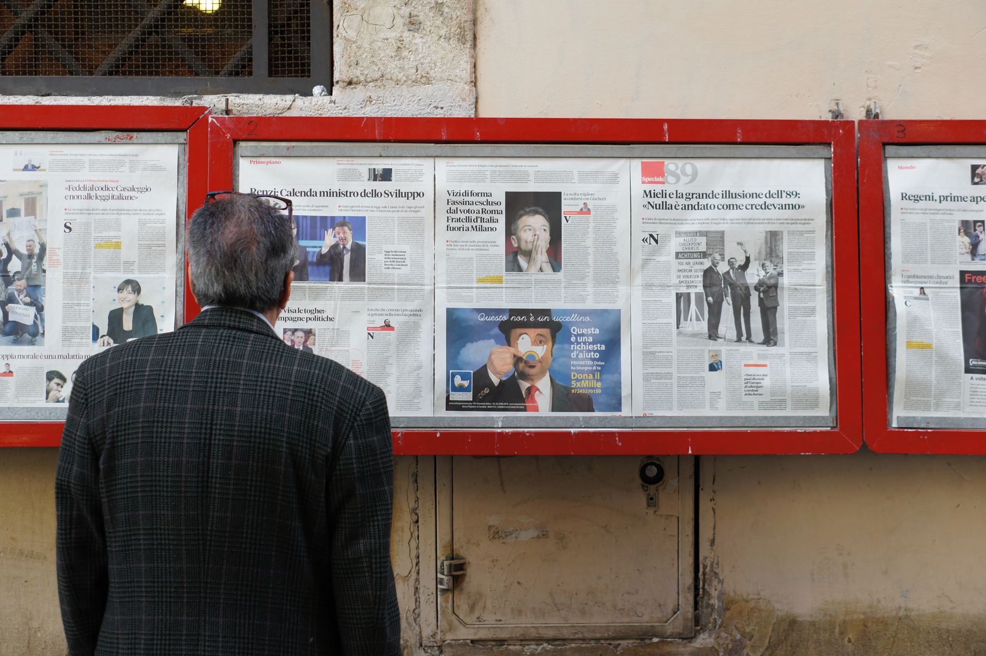 man in front of a notice board